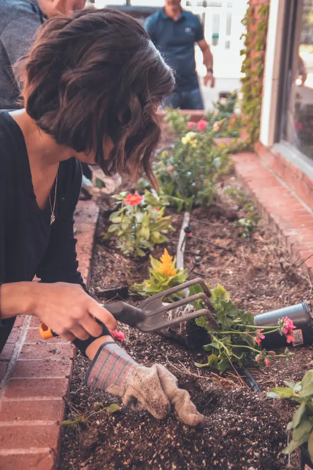 An adult relieving stress by happily gardening, surrounded by greenery, evoking tranquility and connection with nature.