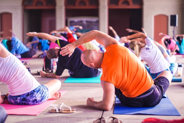 Group of people participating in a yoga class and improving their posture