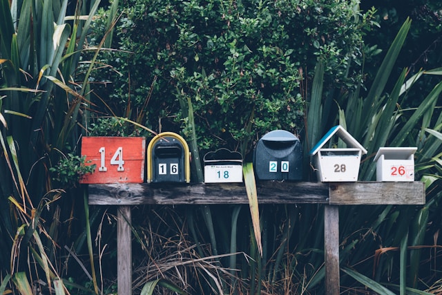 A row of mailboxes in the outdoors, showing that getting mail while traveling in remote areas is easily manageable.