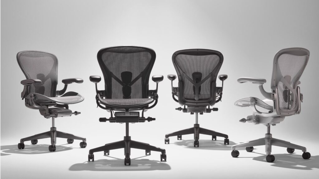 Variety of Herman Miller Aeron Chair ergonomic office chairs with adjustable features, showcased in a line-up to highlight their design and functionality for reducing back pain.