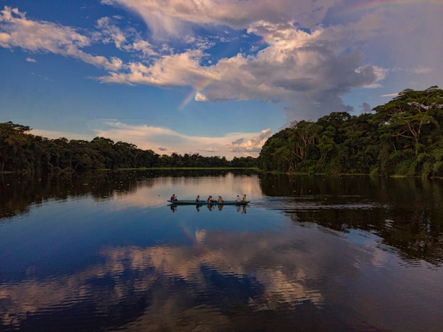 Scenic view of a boat on the Amazon River at sunset, inspired by books about backpacking