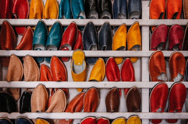 Colorful shoe storage in an RV, displaying a variety of shoes on shelves