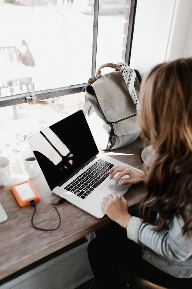 Digital nomad working on a laptop in a cafe