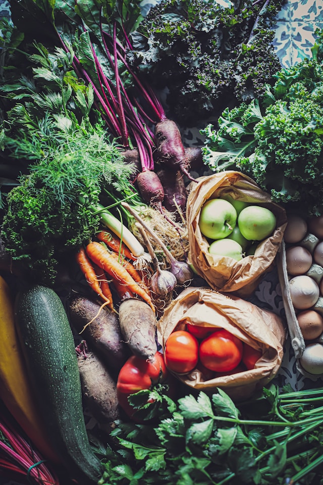 Assortment of fresh organic vegetables and fruits, highlighting the natural health benefits aligning with acupuncture therapy.