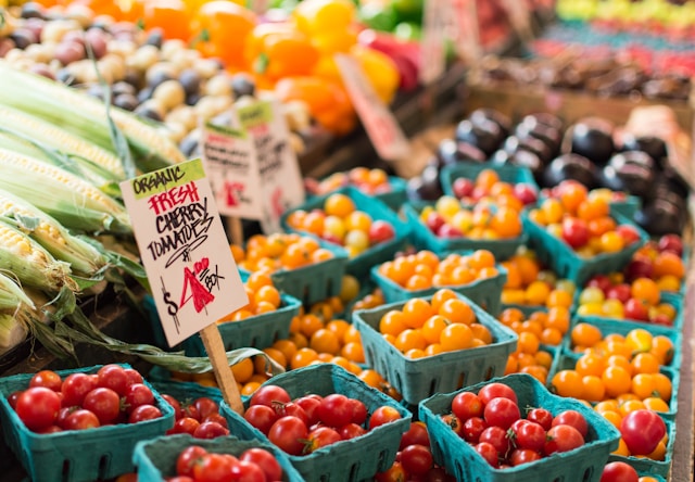 Organic cherry tomatoes displayed at a market stall.