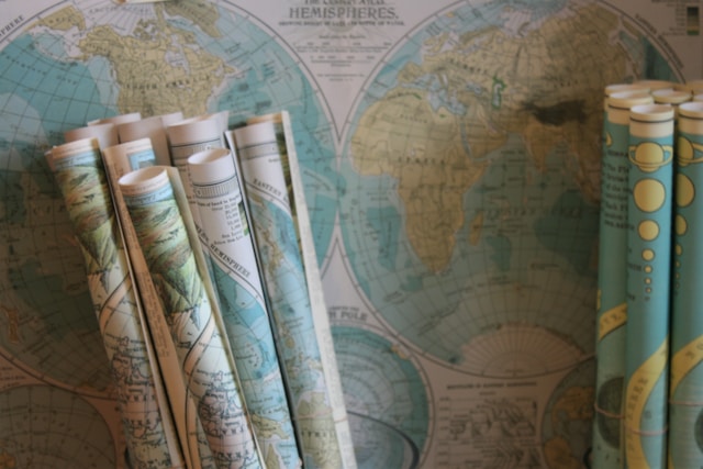 Rolled world maps against a background of more maps