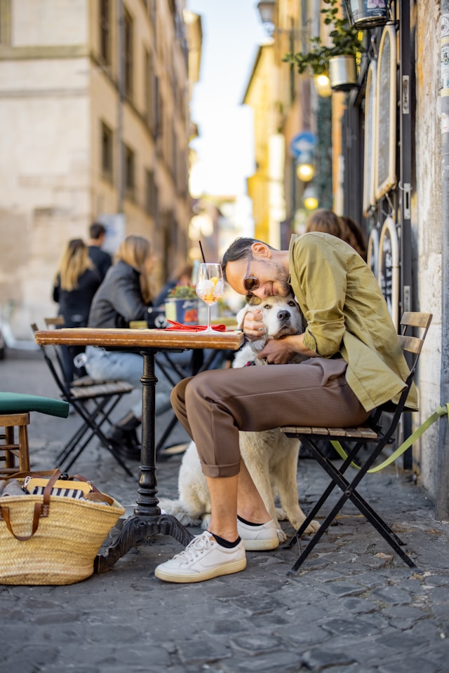 Traveler enjoying time with their dog at an outdoor cafe