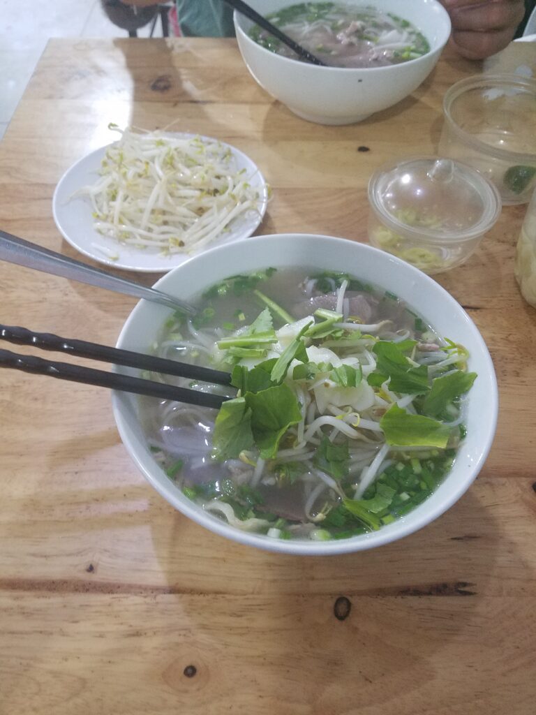 Rob enjoying a fresh bowl of pho in Vietnam.